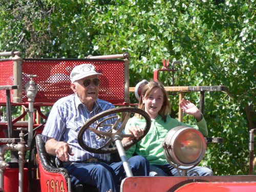 Old Carl Parks and young lady driving Bieber's old fire truck