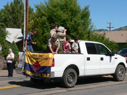 Pickup truck with cub scouts holding their flag of Pack 636