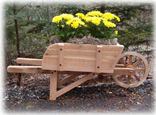 A wooden decorative wheelbarrow with flowers