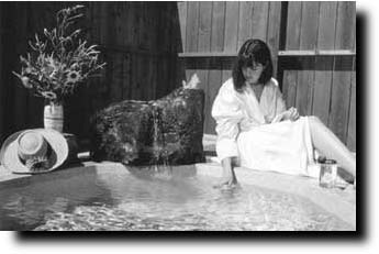 A lady sitting near a hot tub