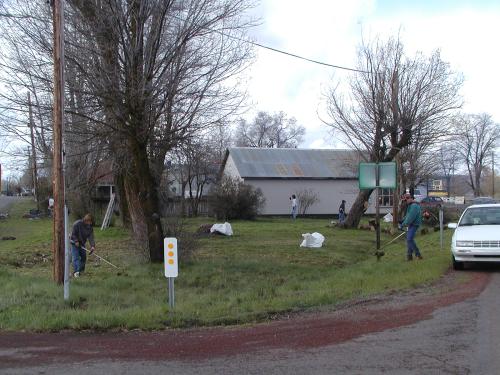 Group cleaning up the triangular plot of land by the highway.
