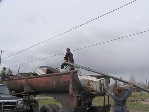Me (the editor) actually working atop a pile of scrap metal being loaded on a round bottom truck.