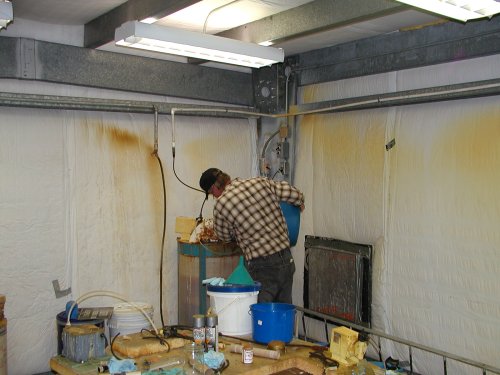 Steve Jackson adding chlorine solution to tank at the Bieber water pump house.
