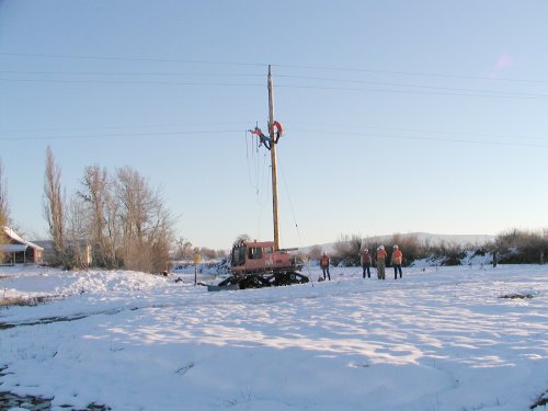 PG and E crew up on pole with "snow cat" transportation.