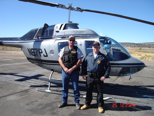 2 sheriff's officers in front of helecopter