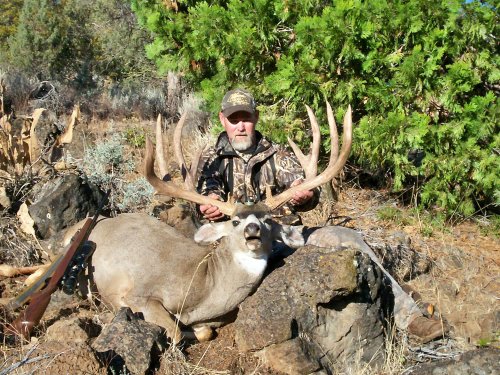Hunter proudly displayts his prize record seting buck.