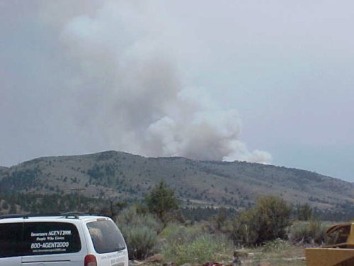 A view of a smoky fire in a canyon
