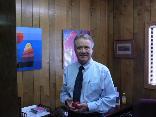Bob holds a "traditional educator's apple" in his office.