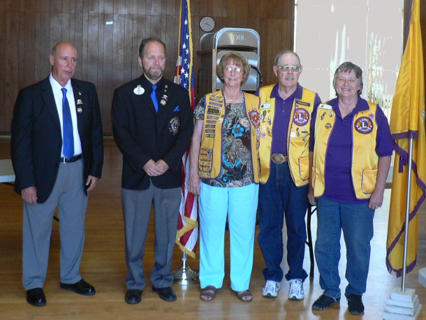5 Lions Club members pose with American and Lions flags.