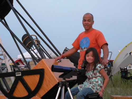 Alvin Huey with a big telescope and small daughter Evelyn.